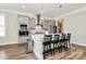 Modern kitchen features a central island with counter seating, pendant lighting and stainless steel appliances at 5129 Whitman Ave, Matthews, NC 28105