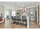 Modern kitchen features a central island with counter seating, pendant lighting and stainless steel appliances at 5129 Whitman Ave, Matthews, NC 28105