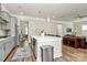 Open concept kitchen with a large center island, stainless steel appliances, and access to the living and dining areas at 5129 Whitman Ave, Matthews, NC 28105