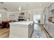 Open concept kitchen with a large center island, stainless steel appliances, and access to the living and dining areas at 5129 Whitman Ave, Matthews, NC 28105