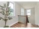 Charming landing area featuring natural light, hardwood floors, and a decorative tree at 5129 Whitman Ave, Matthews, NC 28105