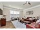 Inviting living room featuring wood floors, a ceiling fan, and modern window shutters at 5129 Whitman Ave, Matthews, NC 28105