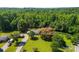 Aerial view of property featuring mature trees, manicured lawn, a barn, and multiple outbuildings at 5425 Creek Run Ct, Kings Mountain, NC 28086