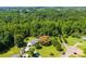 Aerial view of property featuring mature trees, manicured lawn, a barn, multiple outbuildings, and a circular driveway at 5425 Creek Run Ct, Kings Mountain, NC 28086