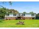 Spacious backyard featuring a well-maintained lawn, fire pit, deck, and mature trees, perfect for outdoor enjoyment at 5425 Creek Run Ct, Kings Mountain, NC 28086