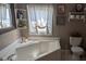 Bathroom features a pristine white tub and window at 5425 Creek Run Ct, Kings Mountain, NC 28086