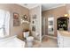 Well-lit bathroom features a soaking tub, separate shower, and tile flooring at 5425 Creek Run Ct, Kings Mountain, NC 28086
