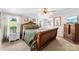 Bedroom features a large wooden bed, ceiling fan, and doorway to the bathroom at 5425 Creek Run Ct, Kings Mountain, NC 28086