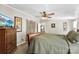 Spacious bedroom boasts a large wooden bed with a ceiling fan and mounted television at 5425 Creek Run Ct, Kings Mountain, NC 28086