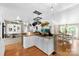 Open-concept kitchen with a breakfast bar, hanging pot rack, and views into the dining and living areas at 5425 Creek Run Ct, Kings Mountain, NC 28086