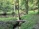 Scenic pond with wooden bridges amid lush greenery reflecting the natural beauty at 5425 Creek Run Ct, Kings Mountain, NC 28086