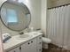 Bright bathroom with modern mirror, vanity, and wood-look floors at 5916 Indian Brook Dr, Matthews, NC 28104