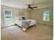 Bedroom filled with natural light, ceiling fan, and views of the landscaped yard at 5916 Indian Brook Dr, Matthews, NC 28104