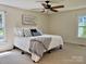 Bright bedroom with natural light features neutral carpet and ceiling fan at 5916 Indian Brook Dr, Matthews, NC 28104