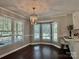 Bright dining nook with a bay window, stylish light fixture, hardwood floors and bar seating at 5916 Indian Brook Dr, Matthews, NC 28104