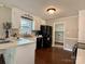 Eat-in kitchen with white cabinets, black appliances, and hardwood flooring, perfect for casual dining at 5916 Indian Brook Dr, Matthews, NC 28104