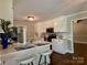 Bright kitchen features white cabinets and a breakfast bar for eat-in dining and serving at 5916 Indian Brook Dr, Matthews, NC 28104