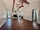 Bright living room features a fireplace, a ceiling fan, hardwood floors, and access to the back yard at 5916 Indian Brook Dr, Matthews, NC 28104