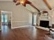 Hardwood floors and white fireplace add warmth to this open living room area at 5916 Indian Brook Dr, Matthews, NC 28104