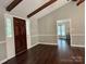Open foyer with dark hardwood floors and a dark wood door leading to the other rooms of the house at 5916 Indian Brook Dr, Matthews, NC 28104