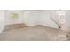 Finished basement area with staircase and adjacent room with tile floors at 7008 Wannamaker Ln, Charlotte, NC 28226