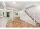 Basement area featuring staircase with carpet, adjacent room with tile floors, and backyard access at 7008 Wannamaker Ln, Charlotte, NC 28226