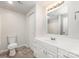 Bathroom vanity features white drawers, mirror, and adjacent toilet and closet at 7008 Wannamaker Ln, Charlotte, NC 28226