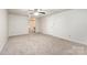 Light filled bedroom featuring neutral carpet, ceiling fan, and neutral walls at 7008 Wannamaker Ln, Charlotte, NC 28226