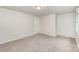 Neutral carpeted bedroom featuring natural light from window and flush mount light at 7008 Wannamaker Ln, Charlotte, NC 28226