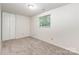 Cozy bedroom with neutral carpet, window with wooded view, and bi-fold closet at 7008 Wannamaker Ln, Charlotte, NC 28226