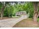 Charming two-story home featuring a two-car garage and a welcoming front porch nestled amongst mature trees at 7008 Wannamaker Ln, Charlotte, NC 28226