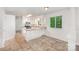 Bright kitchen with ample white cabinetry, granite countertops, modern appliances, and neutral tile flooring at 7008 Wannamaker Ln, Charlotte, NC 28226