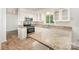 Well-lit kitchen featuring granite countertops, stainless steel appliances, white cabinets and eat-in countertop dining at 7008 Wannamaker Ln, Charlotte, NC 28226