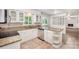 Charming kitchen featuring granite countertops, white cabinets, stainless dishwasher, and neutral tile flooring at 7008 Wannamaker Ln, Charlotte, NC 28226