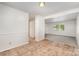 Bright living room featuring neutral walls, tile flooring, carpeted area and abundant natural light at 7008 Wannamaker Ln, Charlotte, NC 28226
