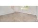 Open concept living room with neutral carpet and natural light from front window at 7008 Wannamaker Ln, Charlotte, NC 28226