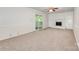 Bright living room with a cozy fireplace, built-in shelving, neutral carpet, and sliding glass doors to the outside at 7008 Wannamaker Ln, Charlotte, NC 28226