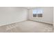 This bedroom is bright, with a window offering natural light and neutral carpet at 707 Olde England Dr, Lincolnton, NC 28092