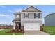Charming two-story home featuring gray siding, a two-car garage, and a well-manicured lawn at 707 Olde England Dr, Lincolnton, NC 28092