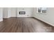 Living room with modern fireplace, hardwood floors, and large windows providing lots of natural light at 707 Olde England Dr, Lincolnton, NC 28092