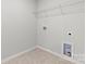 Utility room with neutral tile floor, washer and dryer hookups, and shelving at 707 Olde England Dr, Lincolnton, NC 28092