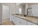 Elegant bathroom featuring double vanity with granite countertop, white cabinets, and a large mirror creating a luxurious feel at 7311 Jerimoth Dr, Charlotte, NC 28215