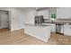 Well-designed kitchen boasts a large island, granite countertops, stainless steel appliances, and sleek white cabinets at 7311 Jerimoth Dr, Charlotte, NC 28215