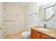 Charming half-bathroom with floral wallpaper, a granite countertop vanity, and tile flooring at 7321 Harrisonwoods Pl, Charlotte, NC 28270