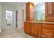 Bathroom featuring double sinks with modern wood cabinets and granite countertops at 7321 Harrisonwoods Pl, Charlotte, NC 28270