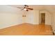 Bedroom featuring hardwood floors and a closet, illuminated by a ceiling fan, in a home for sale at 7321 Harrisonwoods Pl, Charlotte, NC 28270