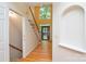 Bright foyer with hardwood floors, an open staircase, and a front door to the landscaped yard at 7321 Harrisonwoods Pl, Charlotte, NC 28270