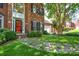 Beautiful brick home featuring well-manicured landscaping and a striking red front door at 7321 Harrisonwoods Pl, Charlotte, NC 28270