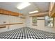 Spacious garage with black and white tile flooring, ample storage, and natural light from two windows at 7321 Harrisonwoods Pl, Charlotte, NC 28270