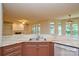 Open kitchen with granite countertops and stainless steel sink overlooking living area at 7321 Harrisonwoods Pl, Charlotte, NC 28270